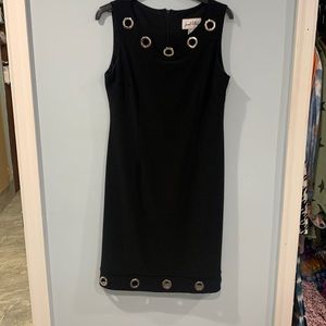 Black w metal open rings.  Top and bottom of dress.  Zipper back